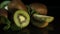 Delicious beautiful fruit kiwi and mint lie on a black table. Reflection of kiwi from the table. HD. Close-up