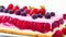Delicious Berry Cake close-up on white. Cake with cream and berry sauce, fresh Berries