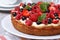 Delicious berry tart with strawberries, raspberries, mint