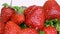 Delicious big ripe red strawberries in rotation. Water drops. Spring and summer food background.