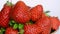 Delicious big ripe red strawberries in rotation. Water drops. Spring and summer food background.