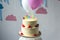 delicious birthday cake with balloons arranged