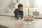 Delicious birthday cake with firework candle for cute little boy in room