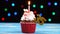 Delicious birthday cupcake with burning candle and number 35 on multicolored blurred lights background