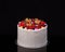 Delicious birthday fruit cake for dessert, black background.