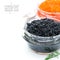 Delicious black caviar in a glass jar, isolated