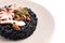 Delicious black risotto with seafood in plate