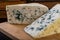 Delicious blue puff cheese on a wooden board. Tasty pleasing cheese prepared for a meal
