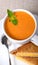 Delicious bowl of tomato soup with grilled cheese sandwich