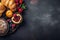 Delicious bread, pastry, croissant, berries, strawberry on rustic black wooden table background, text copy space, top view