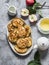 Delicious breakfast - apple pancakes, green tea, fresh apples, cream on a gray background, top view