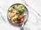 Delicious breakfast  - omelette, vegetables, avocado toast  on a light marble background, top view