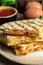 Delicious breakfast quesadilla tortillas with scramble eggs, vegetables, ham and cheese. vertical image. Mexican cuisine. Mexico