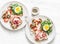 Delicious breakfast, snack, appetizers for wine, tapas - sandwiches with prosciutto, egg, arugula, cherry tomatoes and cream chees