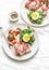 Delicious breakfast, snack, appetizers for wine, tapas - sandwiches with prosciutto, egg, arugula, cherry tomatoes and cream chees