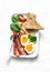 Delicious breakfast - soft boiled egg, bacon, spinach tomatoes salad on light background