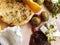 Delicious breakfast: tomatoes and cucumbers, bread, cheese, olives and orange