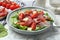 Delicious bresaola salad with tomatoes and parmesan cheese served on white marble table, closeup