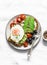 Delicious brunch, breakfast - fried egg, avocado, grilled bread, dried olives, cherry tomatoes. Delicious healthy breakfast, snack