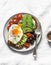 Delicious brunch - fried egg, avocado, grilled bread, dried olives, cherry tomatoes. Delicious healthy breakfast, snack on a light