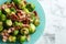 Delicious Brussels sprouts with bacon on marble table, top view