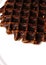 Delicious Brussels waffle in chocolate on a white plate with space for text. Vertical photo. Closeup