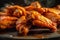 Delicious buffalo wings in hot peppery sauce. Oven baked appetizer. American cuisine specialty. Rustic style kitchen setting