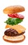 Delicious burger with flying falling ingredients on white background