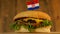 Delicious burger with small Croatian flag on top of them with toothpicks. Yummy hamburger rotating.