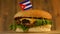 Delicious burger with small Cuban flag on top of them with toothpicks. Yummy hamburger rotating.