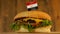 Delicious burger with small Egyptian flag on top of them with toothpicks. Yummy hamburger rotating.