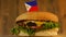 Delicious burger with small Filipino flag on top of them with toothpicks. Yummy hamburger rotating.