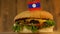 Delicious burger with small flag of Laos on top of them with toothpicks. Yummy hamburger rotating.