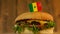 Delicious burger with small flag of Senegal on top of them with toothpicks. Yummy hamburger rotating.