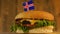 Delicious burger with small Icelandic flag on top of them with toothpicks. Yummy hamburger rotating.