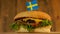 Delicious burger with small Swedish flag on top of them with toothpicks. Yummy hamburger rotating.