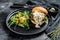 Delicious Burgers with blue cheese, bacon, marbled beef and onion marmalade, a side dish of salad with arugula and oranges. Black