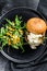 Delicious Burgers with blue cheese, bacon, marbled beef and onion marmalade, a side dish of salad with arugula and oranges. Black