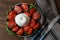 Delicious burrata cheese with tomatoes and basil served on wooden table, flat lay