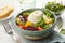 Delicious burrata salad with colorful cherry tomatoes and arugula served on white wooden table