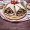 Delicious burrito with meat, beans, and vegetables on a cutting board and a napkin with cherry tomatoes garlic on wooden rusti