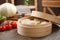 Delicious cabbage rolls in bamboo steamer on table indoors