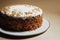 Delicious carrot cake with cream and nuts on stand