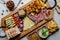 Delicious Charcuterie Board with snacks cheese, toast, ham, blue cheese, almonds, caramelized onions, green onion, honey, toast.