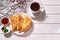 Delicious chebureks calzone with meat with sauces on a white wooden background