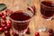 Delicious cherry wine with ripe juicy berries on table, closeup