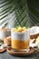 Delicious chia pudding with mango, mint and granola on grey table
