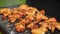Delicious chicken pieces frying on barbecue grill