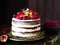 Delicious chocolate cake with figs and berries on a rustic background. Wedding Naked cake with fruits in rustic style.