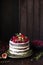 Delicious chocolate cake with figs and berries on a rustic background. Wedding Naked cake with fruits in rustic style.